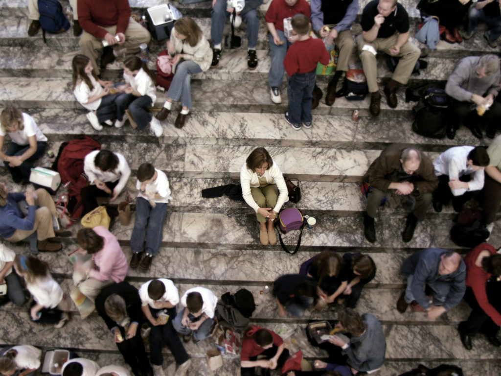 Alone in a crowd ... image was intentionally softened and colors muted to all but the alone person.